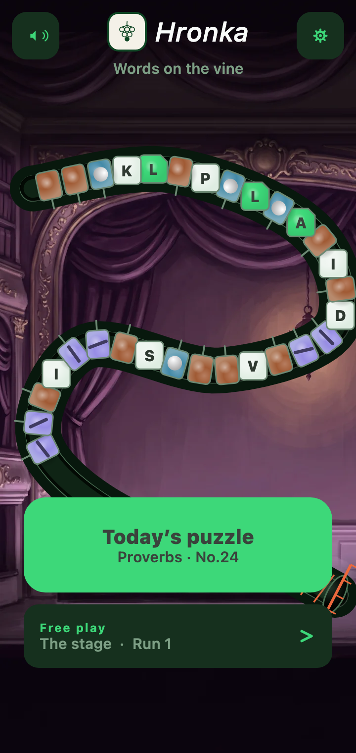 Hronka — the home screen in dark mode: a chain of letter tiles and coloured balls on a curving path over a painted theatre stage, with buttons for today’s puzzle, Proverbs No.24, and free play on the stage, run 1.
